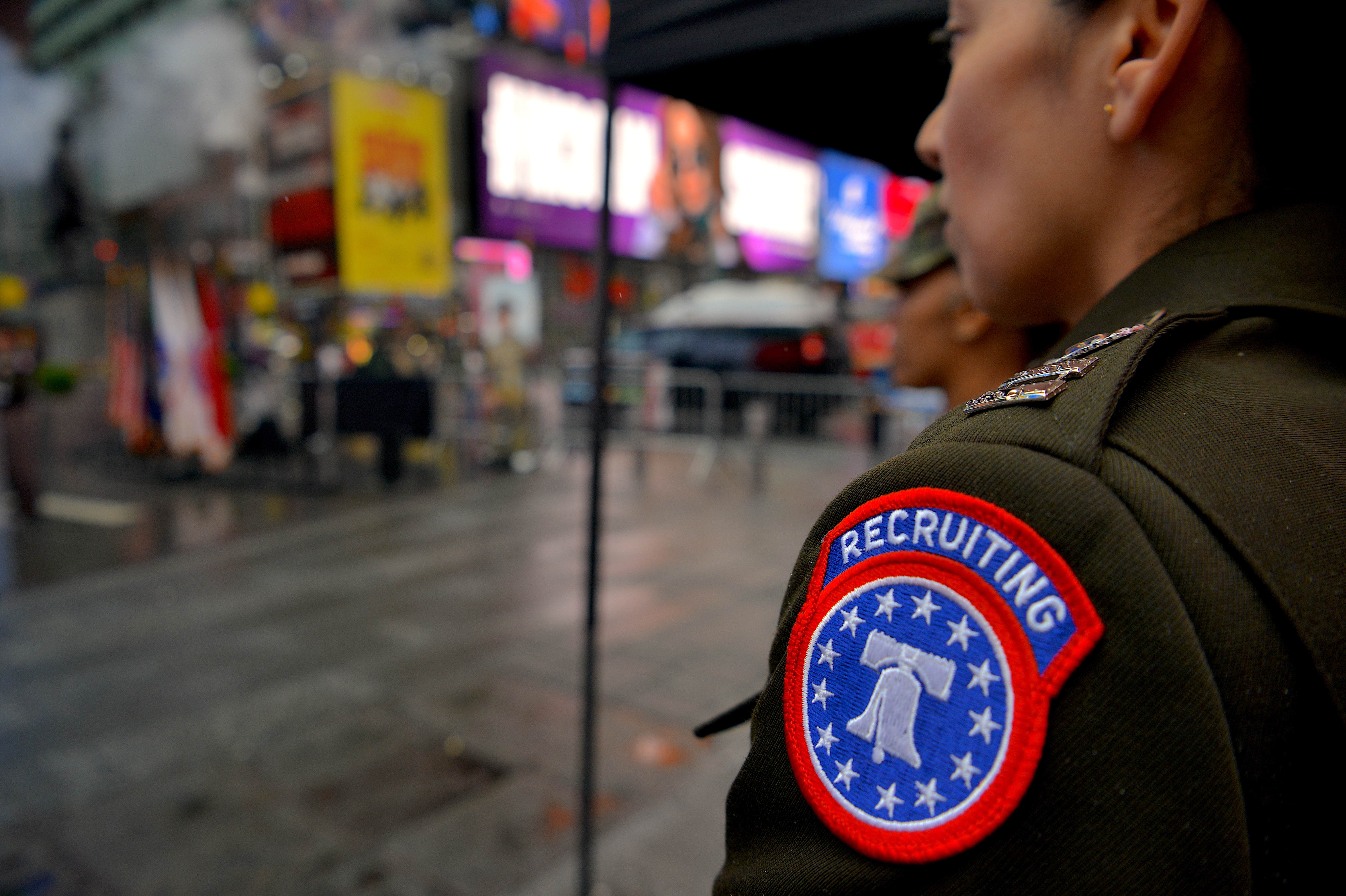 Military recruiter in uniform with Recruiting Command patch in an urban setting